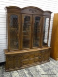 (R1) 2 PIECE OAK CHINA CABINET WITH GLASS INTERIOR SHELVES AND 2 LOWER DOORS WITH 2 CENTER DRAWERS.
