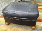 (R1) LEATHER UPHOLSTERED OTTOMAN WITH MAHOGANY CARVED FEET. MEASURES 27 IN X 23 IN X 17 IN. ITEM IS