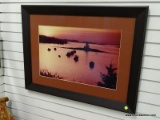 (R2) FRAMED BOAT THEMED PRINT OF BOATS FLOATING ALONG THE WATER AT SUNRISE. IS IN A BLACK FRAME AND