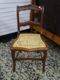 (R2) MAHOGANY CANE BOTTOM SIDE CHAIR. MEASURES 17 IN X 18 IN X 32 IN. ITEM IS SOLD AS IS WHERE IS