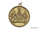 (SC) BRASS NECKLACE PENDANT WITH AN IMAGE OF LIONS STANDING OVER A CIRCULAR CENTER (POSSIBLY A COAT