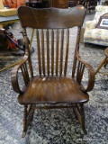 (R2) VINTAGE PINE ROCKING ARM CHAIR WITH ARROW BACK AND PLANK BOTTOM SEAT. MEASURES 24 IN X 31 IN X