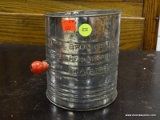 (R2) OLD-FASHIONED HAND HELD FLOUR SIFTER. ITEM IS SOLD AS IS WHERE IS WITH NO GUARANTEES OR