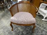 (R2) PECAN WOOD FINISHED BARREL BACK CHAIR WITH CANE BACK AND SIDES AS WELL AS A FEATHER PATTERN