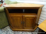 (R2) SOLID OAK CORNER TV STAND WITH A CENTER STORAGE AREA AND 2 LOWER DOORS THAT OPEN TO REVEAL AN