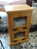 (R2) SOLID OAK POTATO AND ONION BIN WITH CHICKEN WIRE DOORS. MEASURES 15 IN X 10 IN X 26 IN. ITEM IS