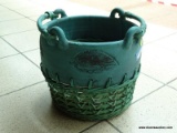 (R2) DOUBLE HANDLED STONE AND WICKER PLANTER. MEASURES 12 IN X 11 IN. ITEM IS SOLD AS IS WHERE IS