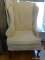 (KIT) OFF-WHITE UPHOLSTERED WING BACK CHAIR WITH MAHOGANY QUEEN ANNE LEGS AND A SLIPCOVER. IS 1 OF A