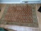 (apartment) machine made oriental rug in rust and ivory. ITEM IS SOLD AS IS WHERE IS WITH NO