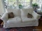 (mbr) white covered love seat- 65 in x 33 in x 34 in. ITEM IS SOLD AS IS WHERE IS WITH NO GUARANTEES
