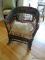 (UPHALL) ANTIQUE WICKER CHILDS ROCKING CHAIR. MEASURES 18 IN X 23 IN X 23 IN. ITEM IS SOLD AS IS