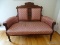 (UPBED 2) VICTORIAN WALNUT SETTEE WITH PINK AND WHITE SHELL PATTERN UPHOLSTERY. MEASURES 55 IN X 24
