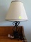 (UPBED 2) METAL DECORATIVE TABLE LAMP WITH CLOTH SHADE. MEASURES 14.5 IN TALL. ITEM IS SOLD AS IS