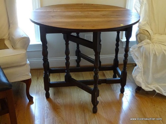 (KIT) ANTIQUE 6 LEGGED ROUND TABLE WITH DROP-LEAF SIDES AND FOLD OUT LEG SUPPORTS. MEASURES 36 IN X