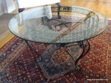(LR) WROUGHT IRON AND GLASS TOP ROUND COFFEE TABLE. MEASURES 37 IN X 19 IN. ITEM IS SOLD AS IS WHERE