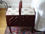 (MBR) ANTIQUE MAHOGANY SEWING CADDY WITH UPHOLSTERED TOP AND HANDLE. MEASURES 18 IN X 11 IN X 22 IN.