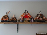 (UPBED 2) LOT OF 4 JAPANESE STYLE DOLLS. 2 ARE MEN, 1 IS A WOMAN, AND 1 IS OF A WOMAN SITTING ON A