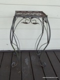 (OUT) CAST IRON LEAF PATTERN PLANT STAND. MEASURES 19 IN X 14 IN X 29 IN. ITEM IS SOLD AS IS WHERE