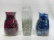 (S6F) THREE LARGE GLASS VASES WITH RED WHITE AND BLUE MARBLES AND FLORAL GLASS. VASES MEASURE 11 AND