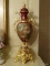(LR) PR. OF DECORATIVE PORCELAIN PORTRAIT PAINTED AND BRASS BASE MANTEL URNS-(POSSIBLY IMPERIAL