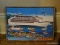 (APTLR) FRAMED HAITIAN OIL ON CANVAS OF CRUISE SHIP ENTERING PORT IN DISTRESSED FRAME, BOUGHT IN