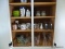 (APTKIT) CABINET LOT OF GLASSES, COFFEE MUGS AND SALT AND PEPPER SHAKERS, ITEM IS SOLD AS IS WHERE