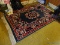 (3RD FL) MACHINE MADE ORIENTAL STYLE RUG IN GREEN, RED, IVORY AND BLACK- 66 IN X 100, ITEM IS SOLD