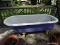 (BCK PRCH) ANTIQUE CAST IRON BATHTUB WITH CAST IRON CLAW FEET. MEASURES 30 IN X 66 IN X 23 IN. ITEM