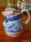 (BCK RM) TEAPOT IN THE FORM OF A PIG IN A BLUE SUIT WITH A BOW TIE, A CANE, AND A FLOWER IN HIS