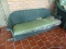 (FRNT PRCH) LLOYD FLANDERS GREEN WICKER HANGING BENCH WITH GREEN STRIPE UPHOLSTERED CUSHION.