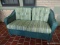 (FRNT PRCH) LLOYD FLANDERS GREEN WICKER 2 CUSHION LOVESEAT WITH GREEN STRIPE UPHOLSTERED CUSHIONS.