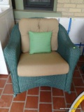 (FRNT PRCH) LLOYD FLANDERS GREEN WICKER ROCKING CHAIR WITH BEIGE UPHOLSTERED CUSHIONS AND A GREEN