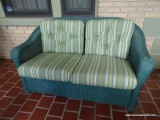 (FRNT PRCH) LLOYD FLANDERS GREEN WICKER 2 CUSHION LOVESEAT WITH GREEN STRIPE UPHOLSTERED CUSHIONS.
