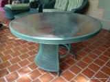 (FRNT PRCH) LLOYD FLANDERS GREEN WICKER, METAL, AND PLEXIGLASS TOP ROUND OUTDOOR PATIO TABLE.
