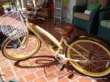 (FRNT PRCH) NIRVE LADIES BICYCLE IN YELLOW WITH FLORAL ACCENTS. ACCORDING TO THE OWNERS IT HAS ONLY