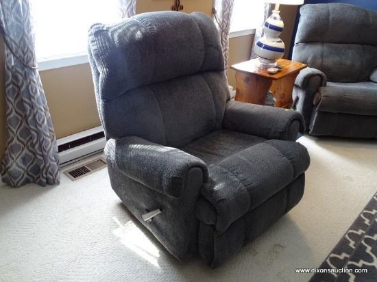 (LR) ONE OF A PR. OF GRAY UPHOLSTERED RECLINERS- SHOWS WEAR IN THE SEAT- 36 IN X 32 IN X 40 IN, ITEM