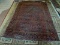 SEMI-ANTIQUE HANDMADE PERSIAN RUG IN MAUVE, BLUE, AND IVORY. MEASURES APPROXIMATELY 6 FT 9 IN X 9 FT