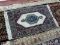 HAND KNOTTED PERSIAN IN IVORY, BLUE, AND RED. MEASURES APPROXIMATELY 1 FT 10 IN X 3 FT 3 IN. ITEM IS