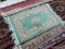 HANDMADE ORIENTAL RUG IN GREEN, IVORY, AND PINK. MEASURES 1 FT 11 IN X 3 FT 3 IN. DOES SHOW SOME