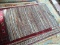 HAND WOVEN LEATHER BRAIDED RUG IN MULTI COLORS. MEASURES APPROXIMATELY 3 FT 9 IN X 6 FT 3 IN. ITEM