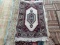 HANDMADE INDIAN RUG IN IVORY, BLUE, AND RED. MEASURES APPROXIMATELY 2 FT X 3 FT. ITEM IS SOLD AS IS
