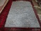 MACHINE MADE ACCENT RUG IN GRAY, WHITE, AND BROWN. MEASURES APPROXIMATELY 5 FT 2 IN X 7 FT 2 IN.