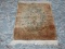 ESTATE OWNED MACHINE MADE ORIENTAL RUG IN SAGE, IVORY, AND BROWN. MEASURES APPROXIMATELY 2 FT X 3 FT