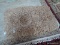 SHAGGY BRAIDED RUG IN BROWN. MEASURES APPROXIMATELY 2 FT 6 X 4 FT 2 IN. ITEM IS SOLD AS IS WHERE IS