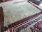 MACHINE MADE ORIENTAL AREA RUG IN GREEN, IVORY, AND GOLD. HAS A VEGETABLE DYE LOOK. MEASURES