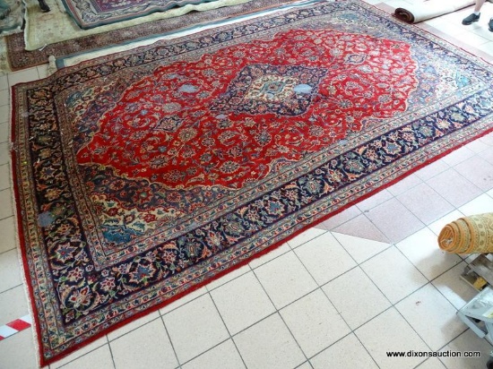 HANDMADE PERSIAN IN RED, BLUE, AND IVORY WITH LARGE CENTER MEDALLION. HAS DAMAGE. MEASURES