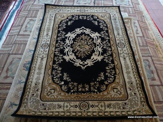 MACHINE MADE ORIENTAL STYLE RUG IN BLACK, BEIGE, AND IVORY. MEASURES APPROXIMATELY 7 FT 2 IN X 5 FT
