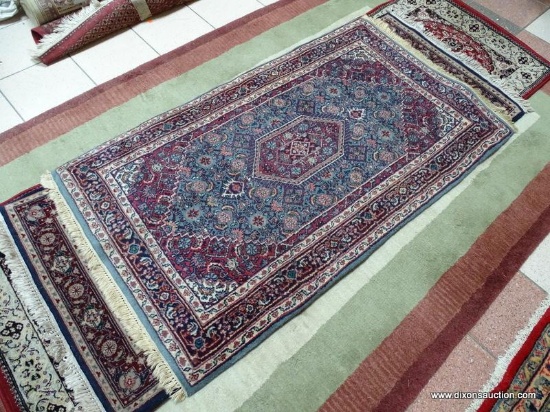 HANDMADE INDIAN AREA RUG IN MAROON, BLUE, AND IVORY. MEASURES APPROXIMATELY 3 FT 6 IN X 5 FT 4 IN.