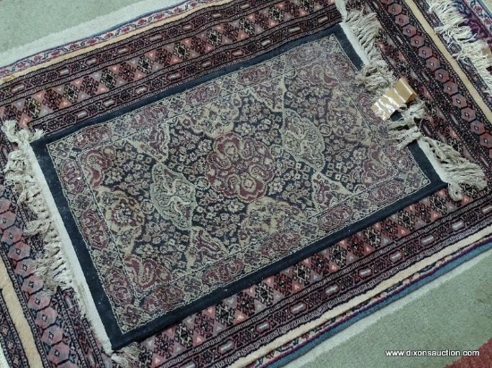 MACHINE MADE ORIENTAL STYLE RUG IN BLUE, IVORY, AND RED. MEASURES APPROXIMATELY 1 FT 7 IN X 3 FT.