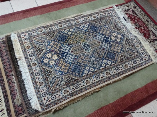 HANDMADE IRANIAN AREA RUG IN IVORY, BLUE, AND BROWN. MEASURES APPROXIMATELY 2 FT 11 IN X 4 FT 6 IN.